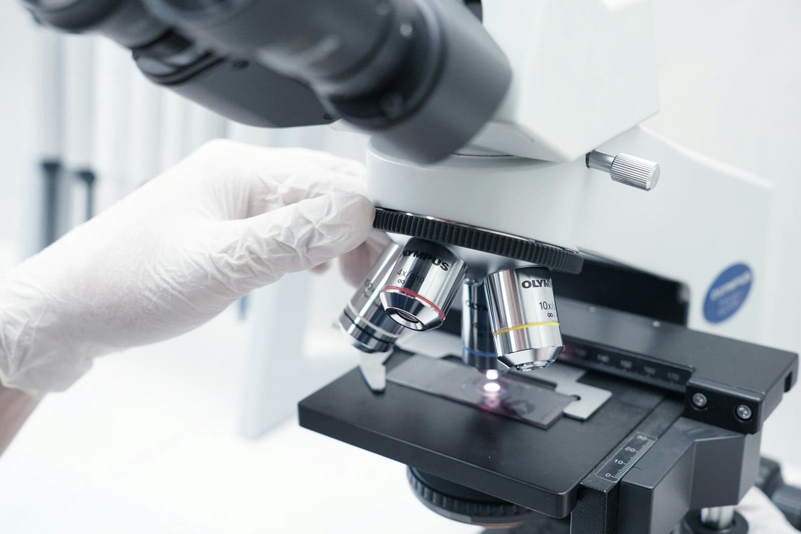 A technician examining a fibre sample under a microscope